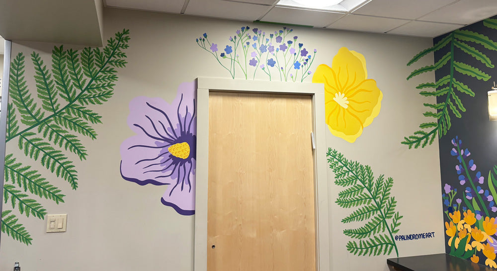 A mural of large scale flowers and ferns